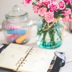 image of a planner on a desk with flowers