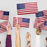 Hands waving flags of the United States