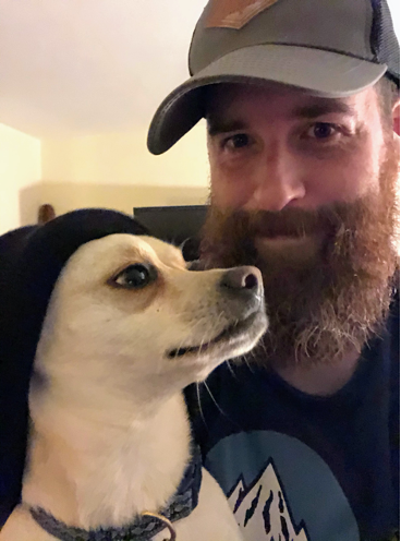 Colin poses with his small white terrier dog