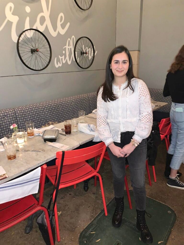 Fatima standing near restaurant table indoors