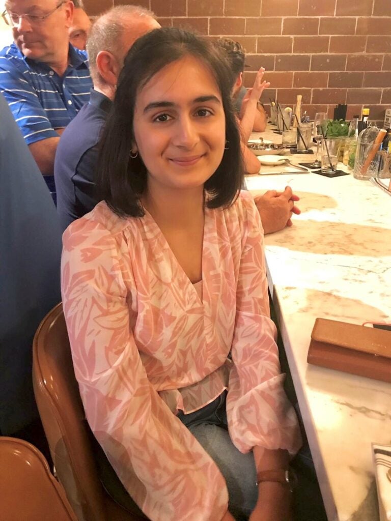 Fatima sitting at restaurant