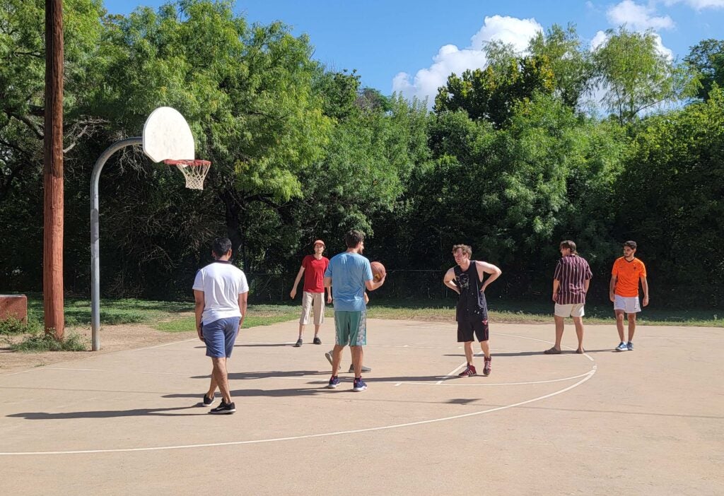Group of male students on basketball court together