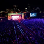 South by Southwest Music Festival in Austin at night with skyline in the background