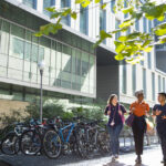 UT Austin students walk together near bikes on campus