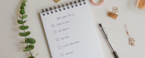 Self care list on notebook with office supplies