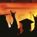 Students graduating and holding up the "UT" hand symbol