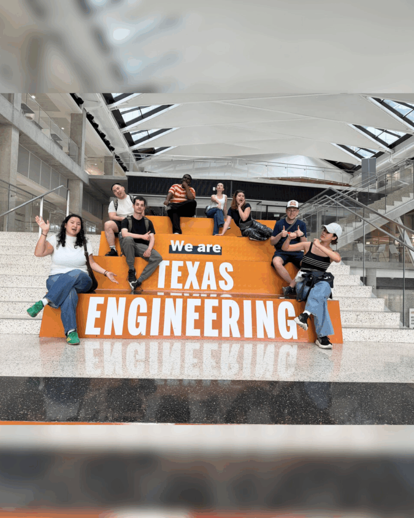 Students sitting together along the Texas Engineering steps in the building