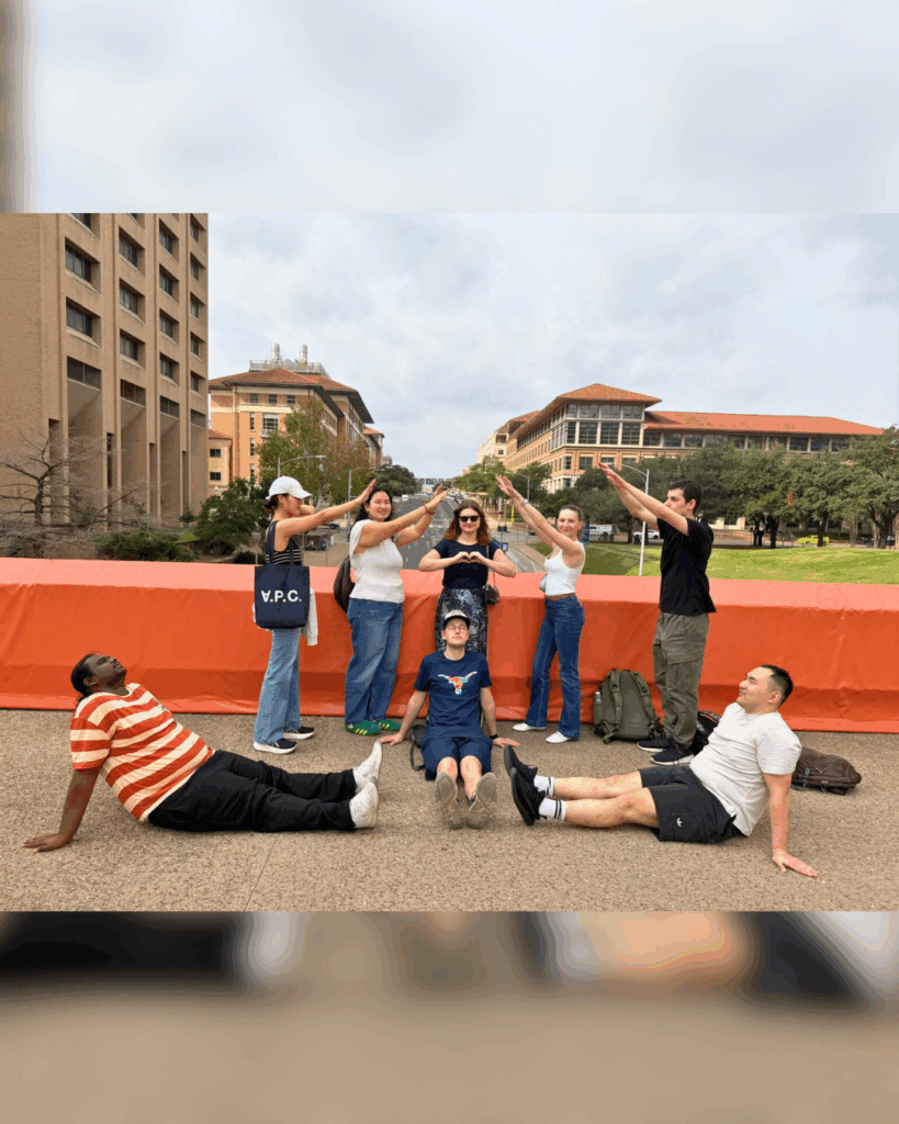 Students posing along bridge