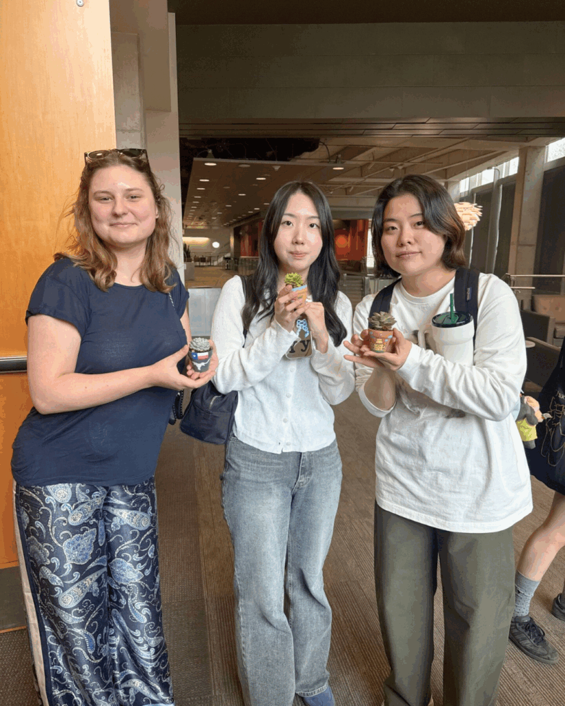 Students holding their small designed plants and pots