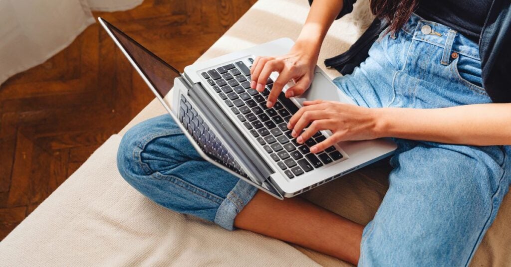 Person typing on their laptop