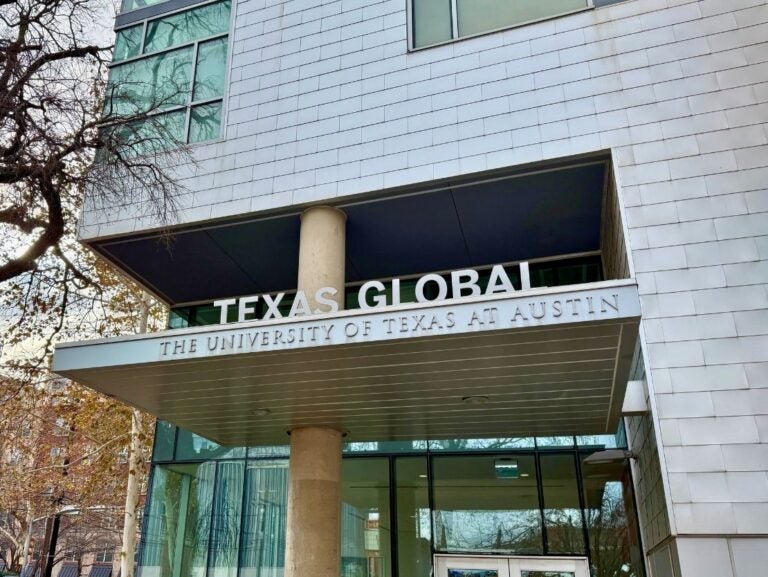 Entrance of Texas Global building at The University of Texas at Austin with modern architecture and glass windows.