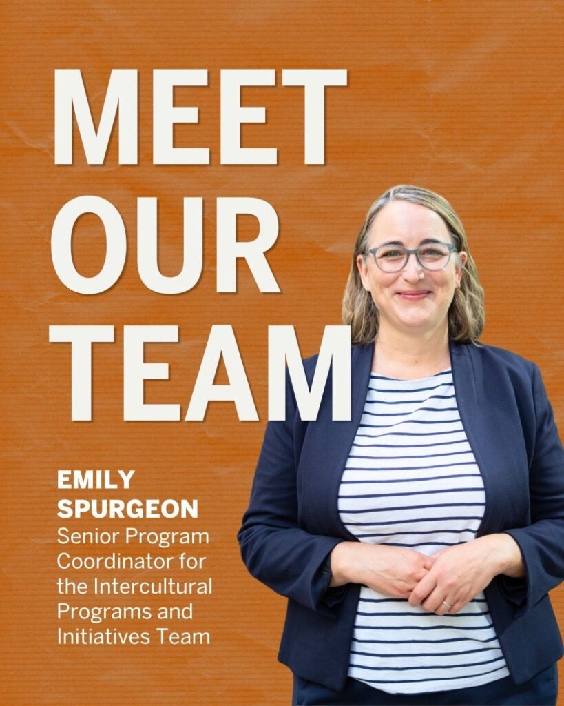 Emily Spurgeon, Senior Program Coordinator, stands smiling in front of an orange background with 'Meet Our Team' text beside her.